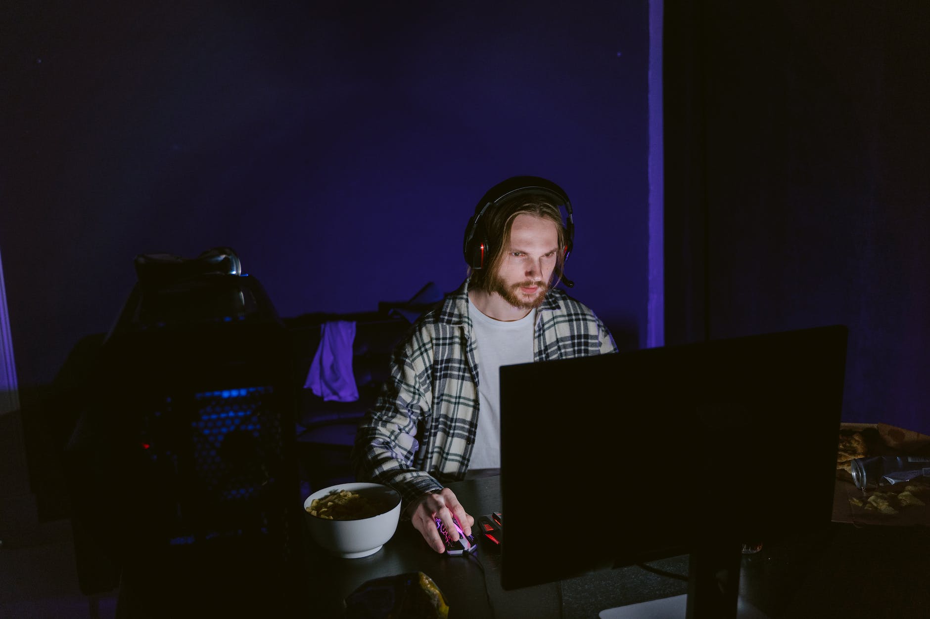 man in plaid shirt playing a computer video game